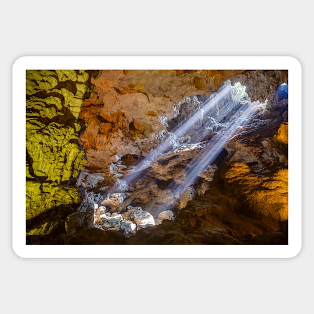 Sun rays shine through ceiling hole in Dau Go cave in Halong Bay, Vietnam Sticker by auradius